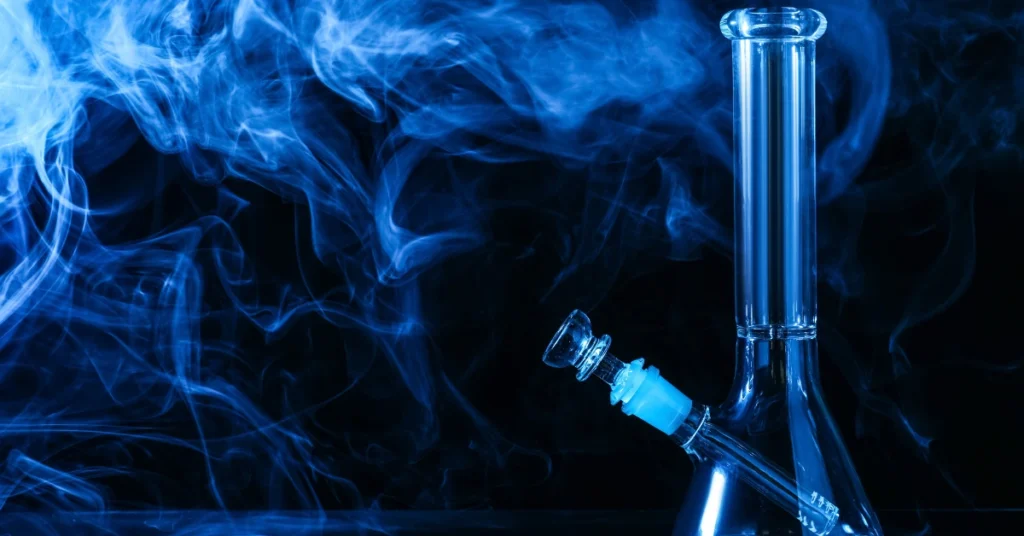 glass bong straight tube with smoke floating around