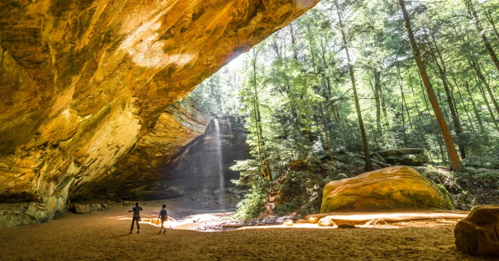 two people exploring ash cave in hocking hills Ohio near Athens