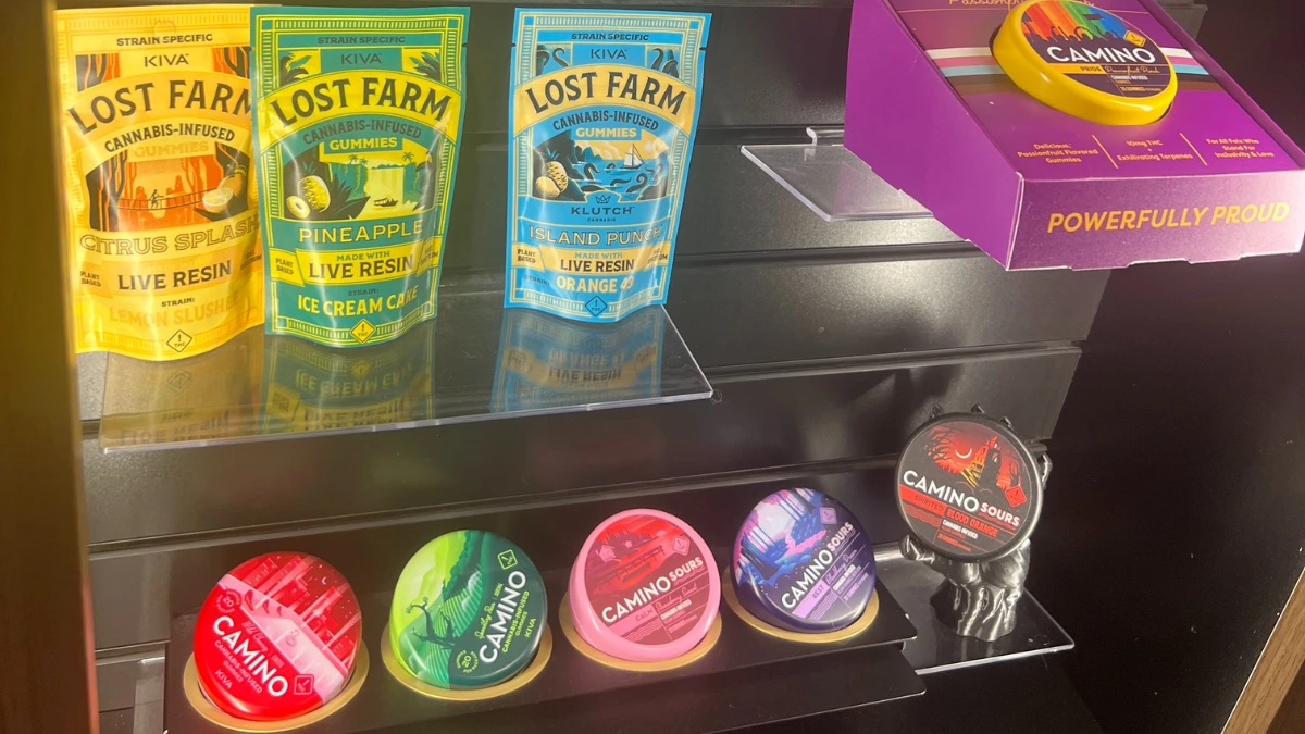 Cannabis products labeled with THC-to-CBD ratios displayed on a counter lightbox.