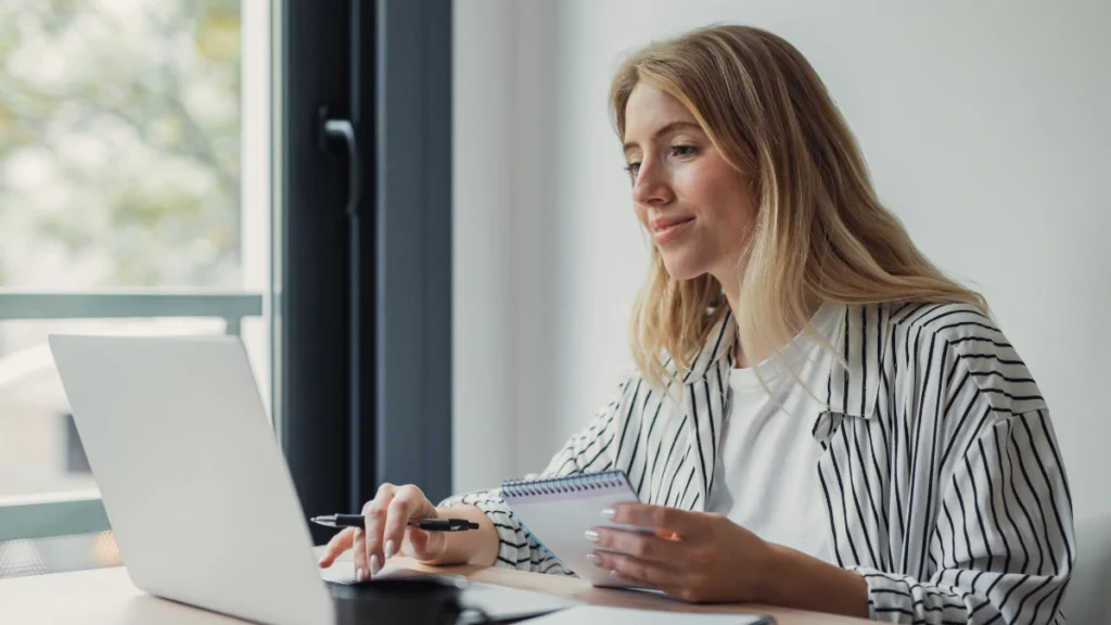 Person at a sunlit desk, relaxed and focused, representing productive daytime energy.